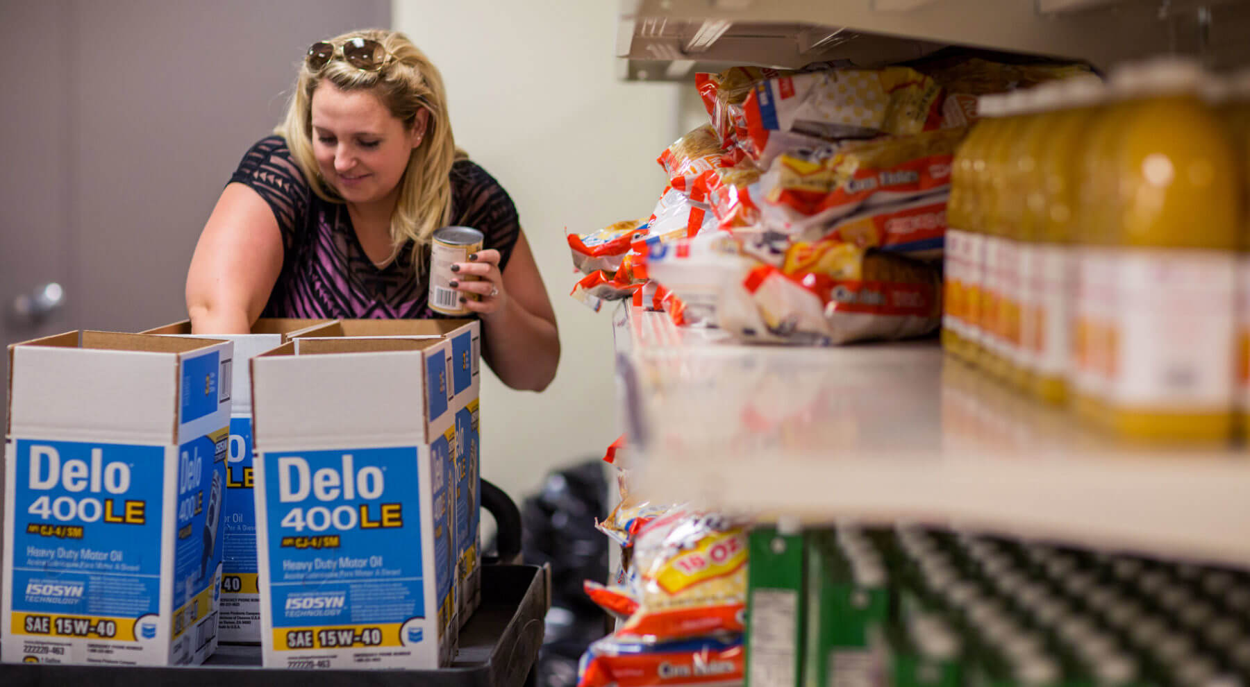 Woman packing boxes of canned food at Pinelake Church