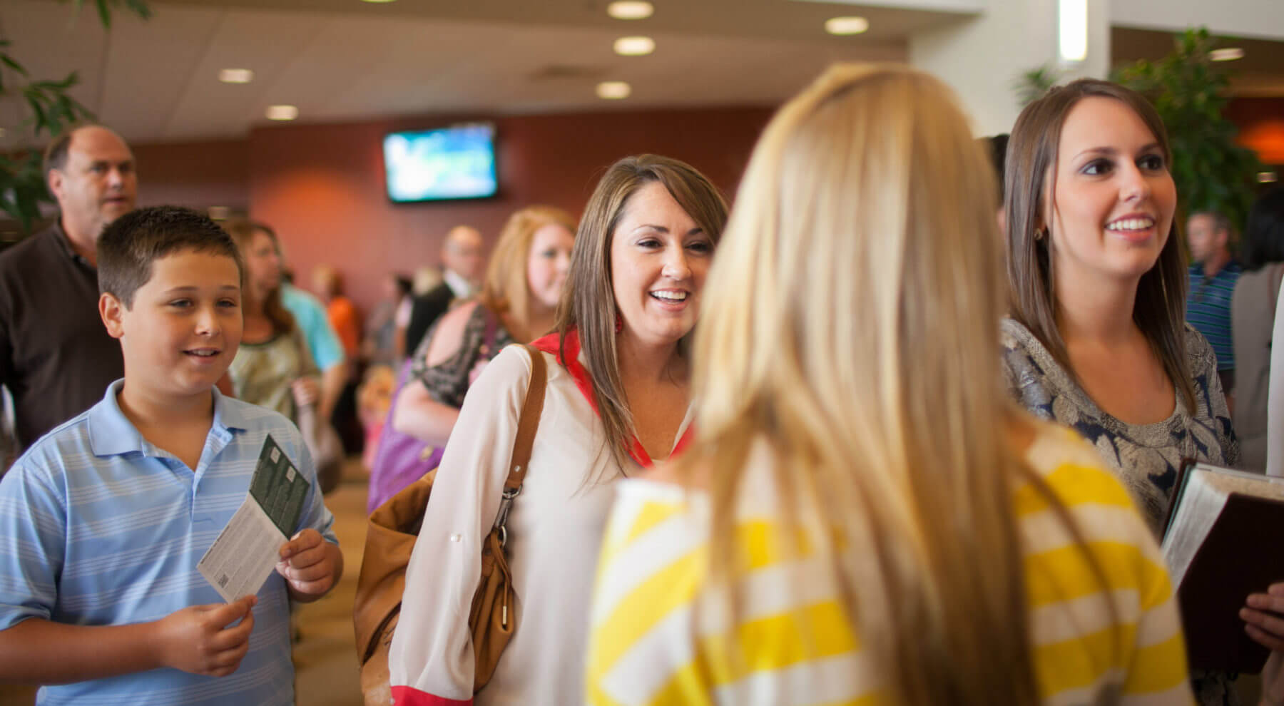 Women smiling while walking out of worship auditorium at Pinelake Church
