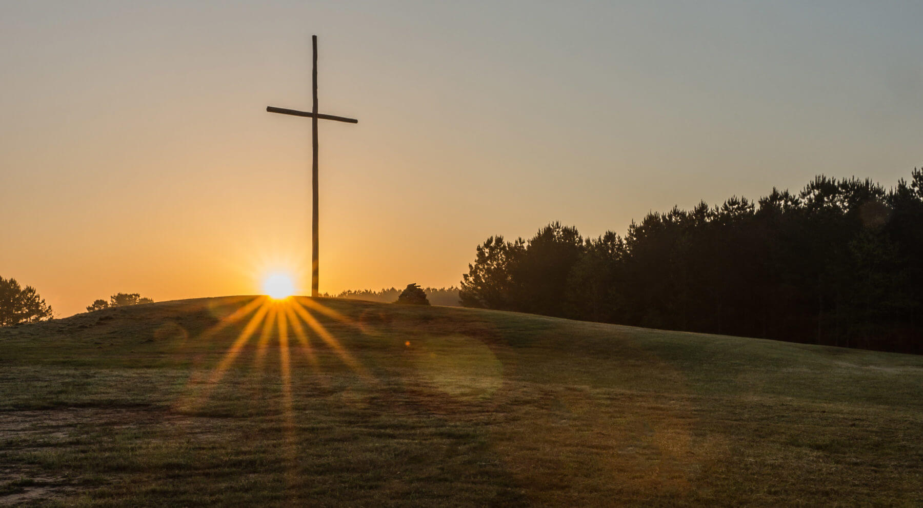 Cross at sunrise at the Pinelake Church Reservoir Campus